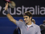 Roger Federer waves to the crowd after his fourth round victory over Milos Raonic at the Australian Open tennis championship on January 21, 2013