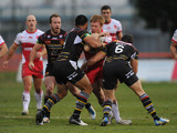 Hull KR's David Hodgson is tackeled by two Catalan Dragons in their match on February 3, 2013