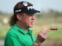 Miguel Angel Jimenez holds his cigar with a pair of chopsticks during the pro-am round ahead of the BMW Masters in Shanghai on October 23, 2013
