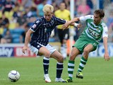 Josh Wright of Millwall contests the ball with Edward Upson of Yeovil during the Sky Bet Championship match between Millwall and Yeovil Town at The Den on August 03, 2013
