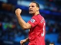 Rio Ferdinand celebrates with the Manchester United supporters at the Etihad Stadium on December 09, 2012.