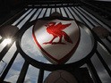 The Liverpool Football Club emblem is displayed on the gates of Anfield Stadium on September 17, 2012