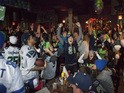 Seattle Seahawks fans including Lynnsey Sturgeon (C) react while watching their team play the Denver Broncos in the Super Bowl at 95 Slide, a sports bar in Seattle on February 2, 2014