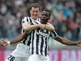 Juventus' Kwadwo Asamoah celebrates with teammate Stephan Lichtsteiner after scoring the opening goal against Chievo Verona during their Serie A match on February 16, 2014