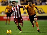 Zeli Ismail of Wolves battles with Sam Saunders of Brentford during the Sky Bet League One game between Wolverhampton Wanderers and Brentford at Molineux on November 23, 2013