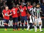 Lille's French forward Nolan Roux is congratulated by his teammates after scoring a goal during the French Cup football match Lille vs Caen on February 11, 2014