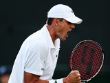 John Isner of the United States celebrates after winning his Gentlemen's Singles first round match against Daniel Smethurst of Great Britain on day two of the Wimbledon Lawn Tennis Championships at the All England Lawn Tennis and Croquet Club at Wimbledon