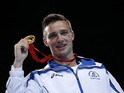 Scotland's Josh Taylor poses on the podium after winning the gold medal in the men's light welter (64kg) final boxing bout at the 2014 Commonwealth Games in Glasgow, Scotland, on August 2, 2014