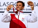 Tom Daley of England celebrates on the podium after winning the Gold medal in the Men's 10m Platform Final at the Royal Commonwealth Pool during day ten of the Glasgow 2014 Commonwealth Games on August 2, 2014 