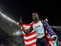 Justin Gatlin of the US gestures after he won gold in the men's 100m final, 22 August 2004