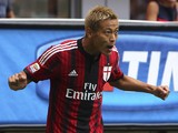 Keisuke Honda of AC Milan celebrates after scoring the opening goal during the Serie A match between AC Milan and SS Lazio at Stadio Giuseppe Meazza on August 31, 2014