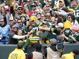 Jordy Nelson #87 of the Green Bay Packers celebrates with fans after a 59-yard touchdown pass reception in the first quarter of the game against the Carolina Panthers at Lambeau Field on October 19, 2014