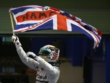 Lewis Hamilton of Great Britain and Mercedes GP celebrates in Parc Ferme after winning the World Championship and the Abu Dhabi Formula One Grand Prix at Yas Marina Circuit on November 23, 2014