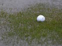A golf ball is surrounded by flooding as rain stops play during round one of the South African Open Golf Championships at the Durban Country Club on December 16, 2010