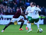 Morgaro Gomis of Hearts is tackled by Danny Handling of Hibernian during the Scottish Championship match between Heart of Midlothian F.C. and Hibernian F.C. at Tynecastle Stadium on January 3, 2015