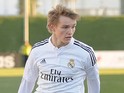 Martin Odegaard of Real Madrid Castilla takes on two Athletic Club B players during the Segunda Division B match against Athletic Club B on February 8, 2015