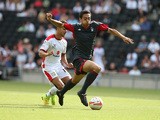 Tyler Walker of Nottingham Forest attempts to move forward with the ball away from George Baldock of MK Dons during the Pre-Season Friendly between MK Dons and Nottingham Forest at Stadium mk on July 27, 2014