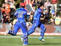 Afghanistan batsman Shapoor Zadran celebrates with teammate Hamid Hassan after hitting the winning runs to defeat Scotland in their 2015 Cricket World Cup Group A match in Dunedin on February 26, 2015