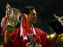 Liverpool's Robbie Fowler holds aloft The Worthington Cup and Man of the Match trophies after beating Birmingham City at The Millenium Stadium in Cardiff Sunday 25 February 2001