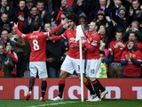Marouane Fellaini of Manchester United is congratulated by teammates Juan Mata of Manchester United and Wayne Rooney of Manchester United after scoring the opening goal during the Barclays Premier League match between Manchester United and Tottenham Hotsp