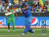 India's batman Rohit Sharma plays a shot off the Bangladesh bowling during the 2015 Cricket World Cup quarter-final match between India and Bangladesh at the Melbourne Cricket Ground (MCG) on March 19, 2015