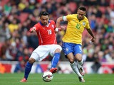 Gonzalo Jara of Chile and Neymar of Brazil comnpete for the ball during the international friendly match between Brazil and Chile at the Emirates Stadium on March 29, 2015