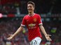 Ander Herrera of Manchester United celebrates as he scores their first goal during the Barclays Premier League match between Manchester United and Arsenal at Old Trafford on May 17, 2015 