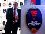 Formar Brazilian football player and team manager of Delhi Dynamos Roberto Carlos poses alongside the team shield during a press confrence in the Indian capital New Delhi on July 9, 2015
