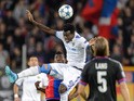 Tel Aviv's Nigerian midfielder Nosa Igiebor heads the ball between Basel's Swiss forward Breel Embolo (L) and Basel's Swiss defender Michael Lang during the UEFA Champions League playoff football match between FC Basel and Maccabi Tel Aviv at the St Jakob