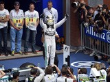 Mercedes AMG Petronas F1 Team's British driver Lewis Hamilton celebrates winning in the parc ferme at the Spa-Francorchamps circuit in Spa on August 23, 2015