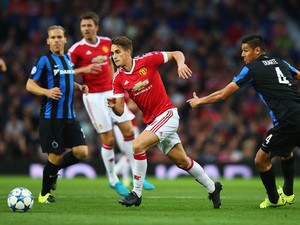 Adnan Januzaj of Manchester United goes past Oscar Duarte of Club Brugge during the UEFA Champions League Qualifying Round Play Off First Leg match between Manchester United and Club Brugge at Old Trafford on August 18, 2015