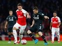 Arsenal's Olivier Giroud is pursued by James Milner of Liverpool on August 24, 2015