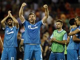 Zenit's Belgian defender Nicolas Lombaerts (2nd L) and teammate Zenit's Portuguese defender Luis Neto (L) celebrate their victoy after the UEFA Champions League group H football match Valencia CF vs FC Zenit at the Mestalla stadium in Valencia on Septembe