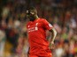 Christian Benteke of Liverpool runs with the ball during the Barclays Premier League match between Liverpool and A.F.C. Bournemouth at Anfield on August 17, 2015