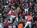 Arsenal's Chilean striker Alexis Sanchez (C) celebrates scoring his goal with team mates Arsenal's German midfielder Arsenal's English midfielder Theo Walcott (L) during the English Premier League football match between Arsenal and Manchester United at th