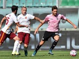 Franco Vazquez (R) of Palermo is challenged by Radja Nainggolan (C) and Miralem Pjanic of Roma during the Serie A match between US Citta di Palermo and AS Roma at Stadio Renzo Barbera on October 4, 2015 in Palermo, Italy.