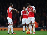 Mesut Oezil of Arsenal (L) and Olivier Giroud of Arsenal look dejected after conceding a goal during the Barclays Premier League match between Arsenal and Tottenham Hotspur at the Emirates Stadium on November 8, 2015 in London, England.