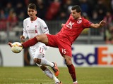 Syarhey Kislyak (R) of FC Rubin Kazan is challenged by Roberto Firmino of Liverpool FC during the UEFA Europa League group B match between FC Rubin Kazan and Liverpool FC at the Kazan Arena Stadium on November 05, 2015 in Moscow, Russia. 
