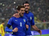 Italy's midfielder Claudio Marchisio (L) celebrates with Italy's forward Graziano Pelle (R) after scoring a penalty during the friendly football match between Italy and Romania, on November 17, 2015