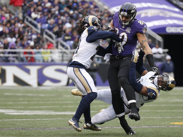 Tight end Crockett Gillmore #80 of the Baltimore Ravens carries the ball against cornerback Janoris Jenkins #21 of the St. Louis Rams and strong safety T.J. McDonald #25 of the St. Louis Rams in the first quarter at M&T Bank Stadium on November 22, 2015