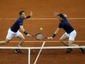 Andy Murray (L) and Jamie Murray (R) of Great Britain compete in the doubles match against David Goffin and Steve Darcis of Belgium on day two of the Davis Cup Final 2015 at Flanders Expo on November 28, 2015