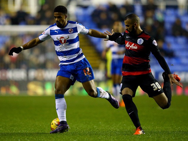 Garath McCleary of Reading holds off Sandro of QPR during the Sky Bet Championship match between Reading and Queens Park Rangers on December 3, 2015