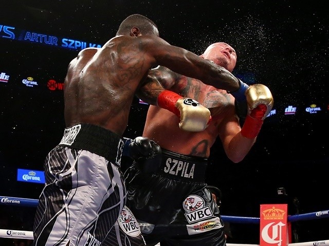 Deontay Wilder punches Artur Szpilka during their WBC Heavyweight Championship bout at Barclays Center on January 16, 2016
