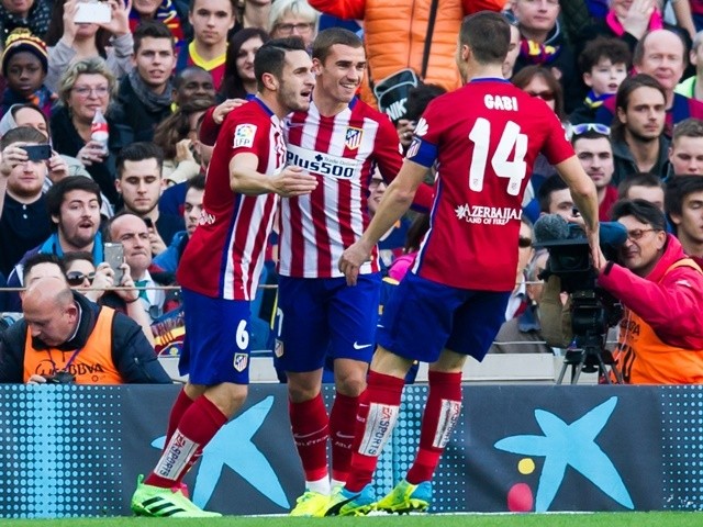 Koke celebrates with Antoine Griezmann and Gabi Fernandez after scoring the opening goal during the La Liga match between FC Barcelona and Club Atletico de Madrid at Camp Nou on January 30, 2016