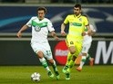 Max Kruse of Wolfsburg is pursued by Stefan Mitrovic of Gent in the Champions League on February 17, 2016