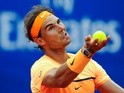 Rafael Nadal serves against Fabio Fognini during day five of the Barcelona Open on April 22, 2016