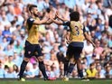 Olivier Giroud celebrates with Mohamed Elneny during the Premier League game between Manchester City and Arsenal on May 8, 2016