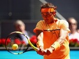 Rafael Nadal plays a backhand against Andrey Kuznetsov in their second-round match during day four of the Mutua Madrid Open on May 3, 2016
