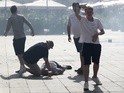 An England fan is unconscious on the ground after clashes ahead of the game against Russia on June 11, 2016