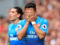 Alexis Sanchez hides his face in shame during the Premier League game between Liverpool and Arsenal on August 27, 2017